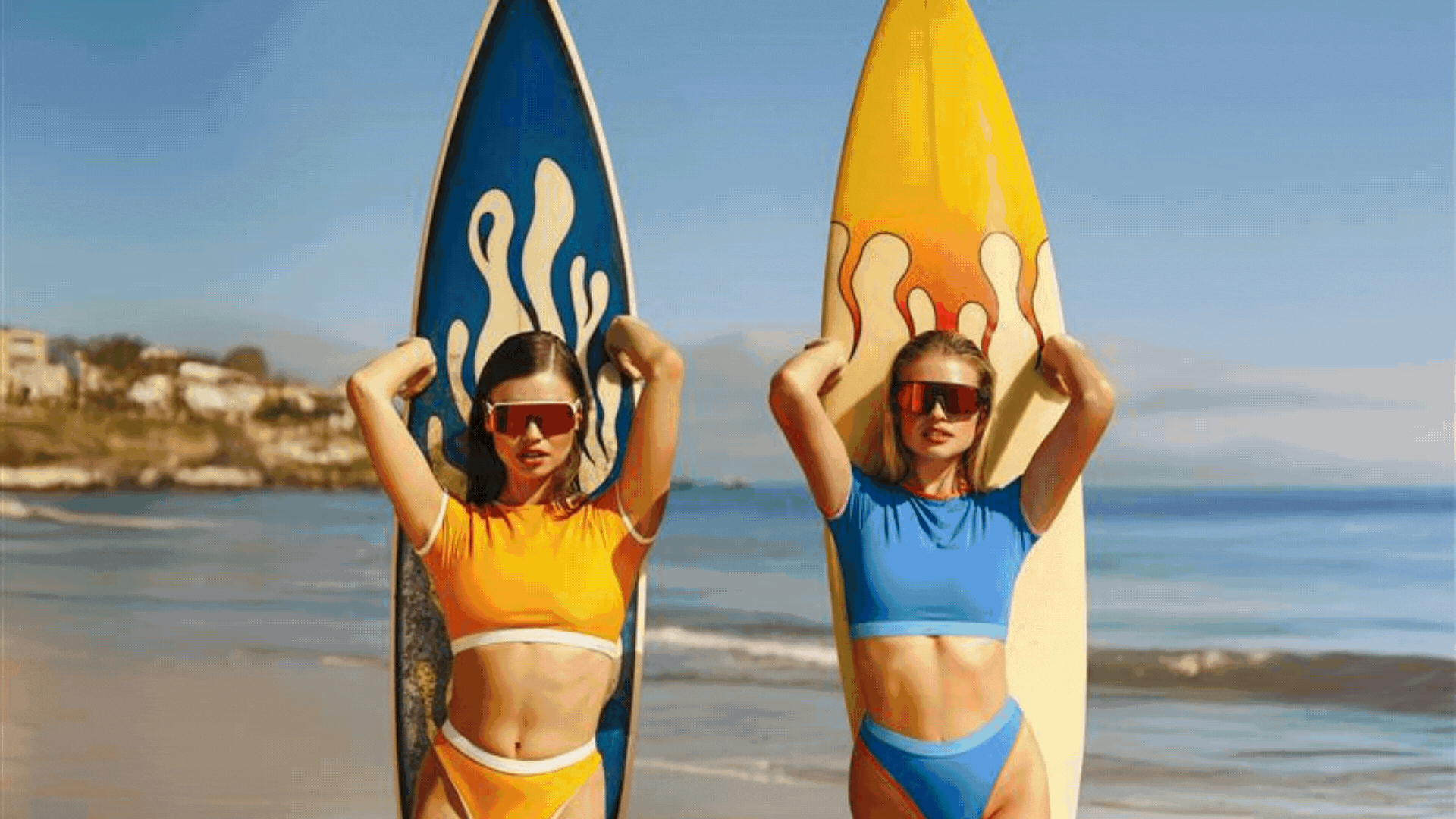 2 girls on the beach with surfboards